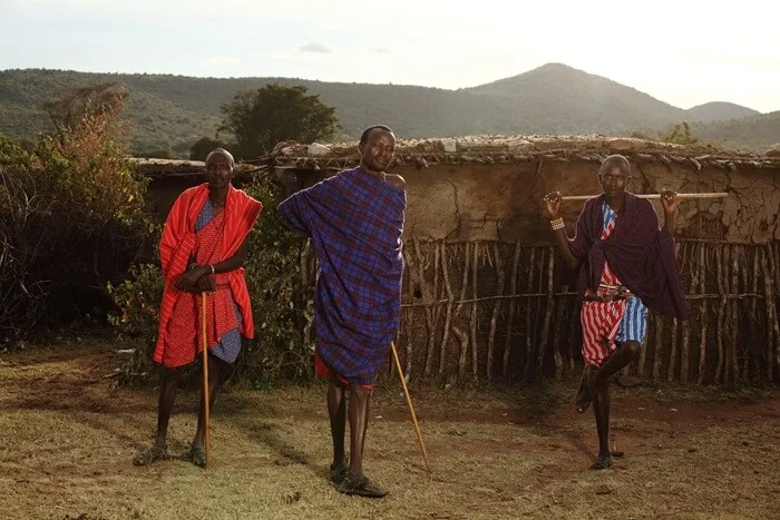 Maasai community members outside a village dwelling